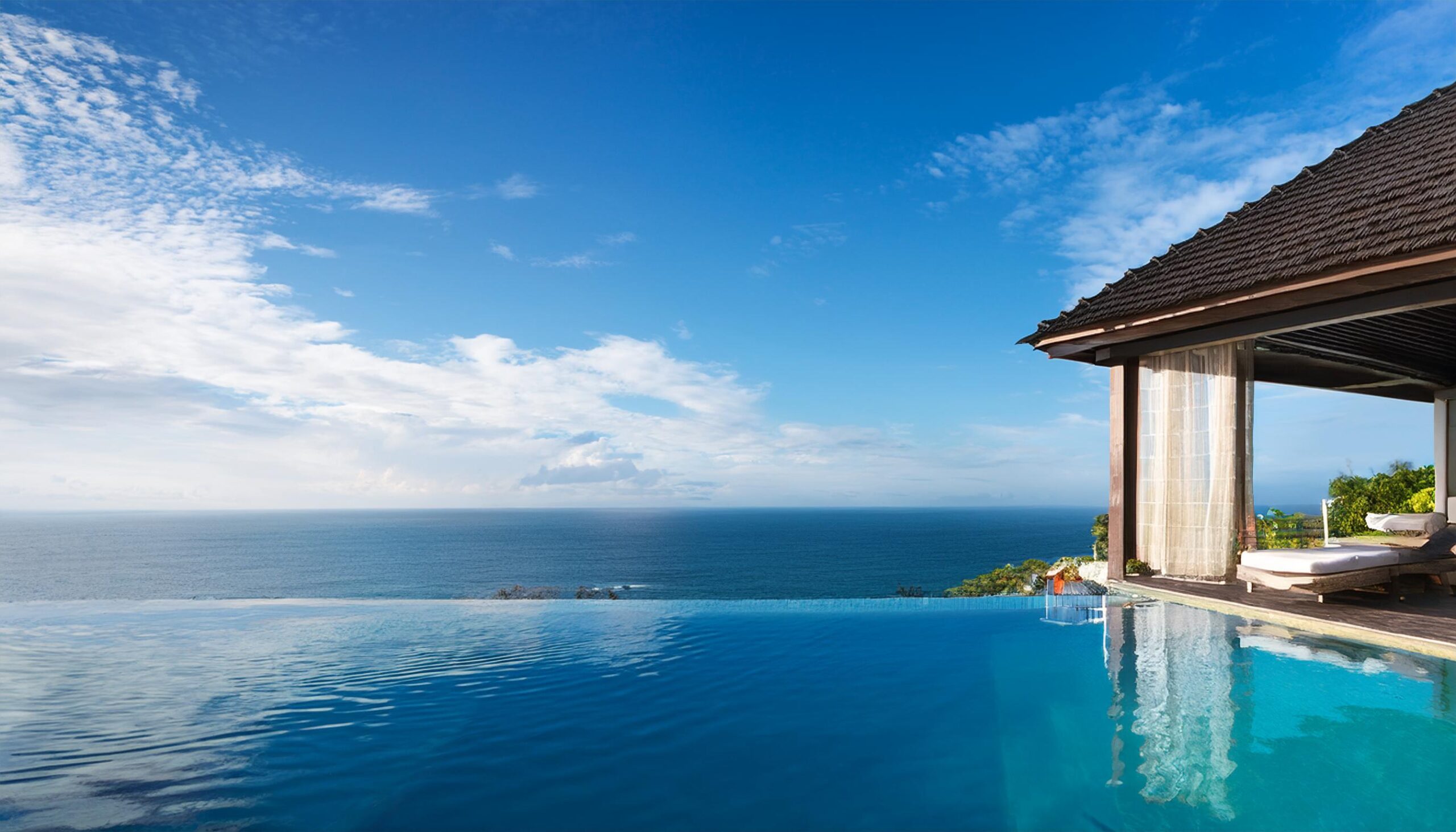 Firefly a villa with balinese tropical style with black tile roof on the edge of cliff with infinity